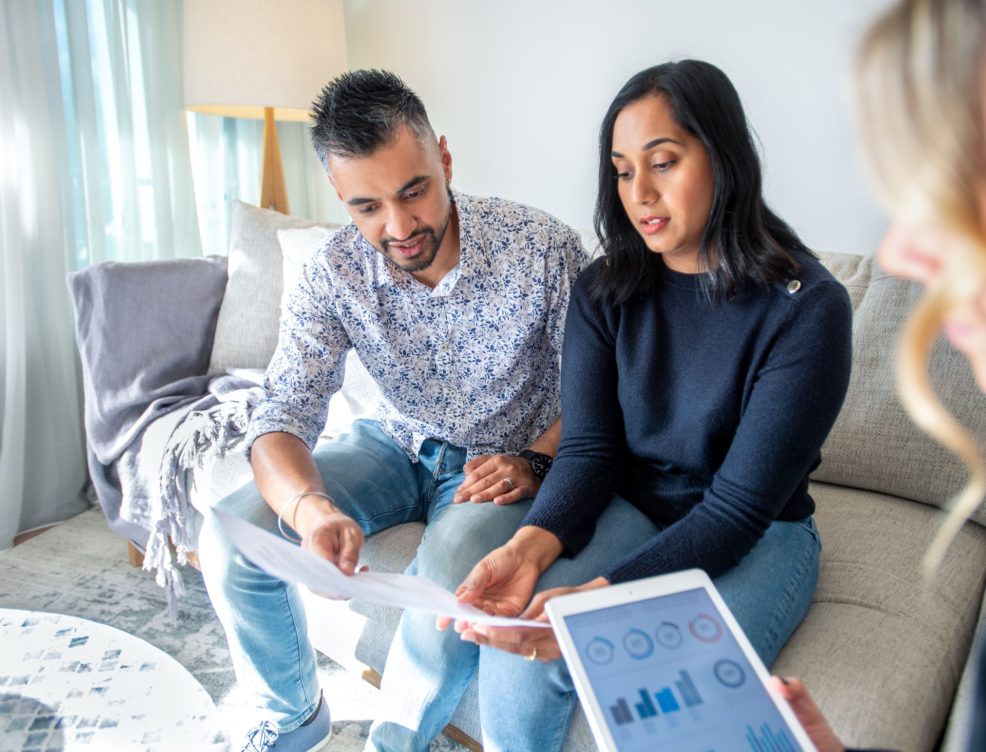 Mature couple meeting with financial advisor or real estate agent at home.